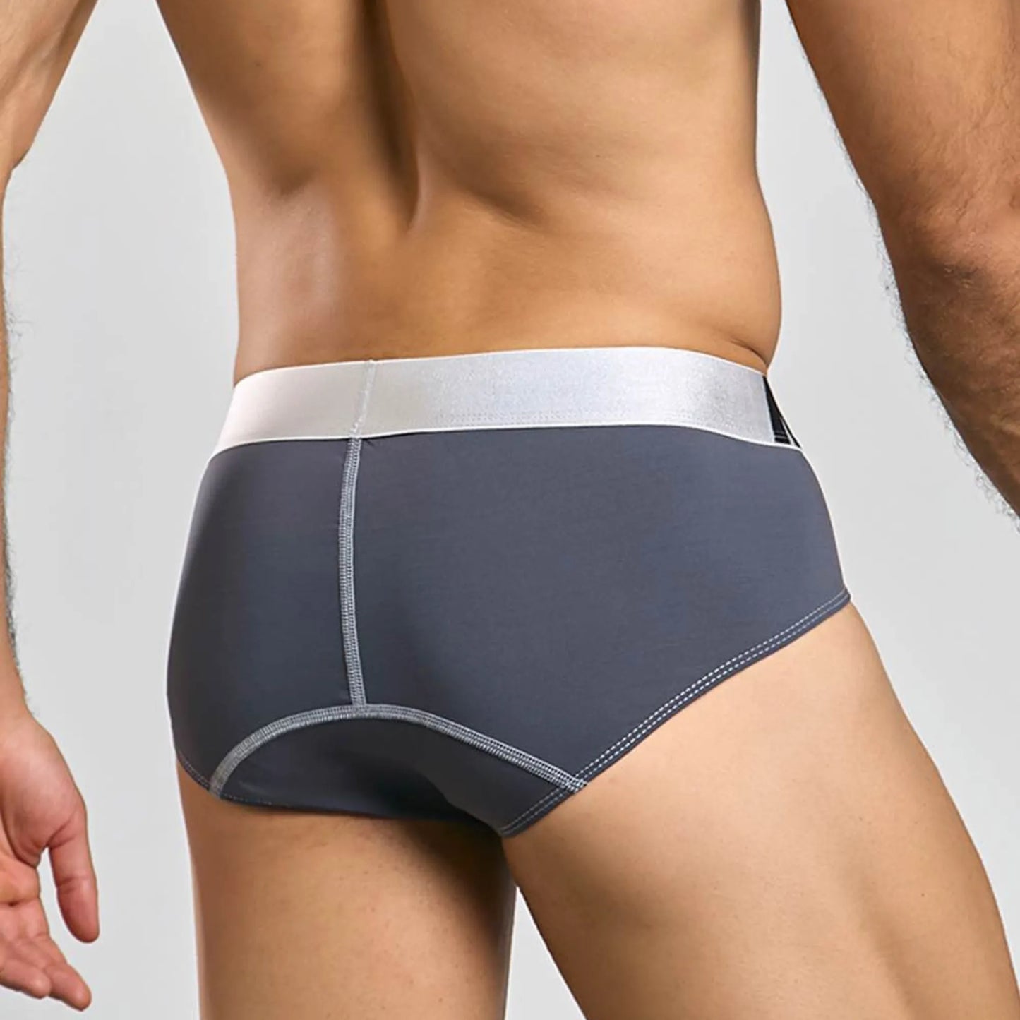 Men's stretch microfiber brief in grey, back view on model