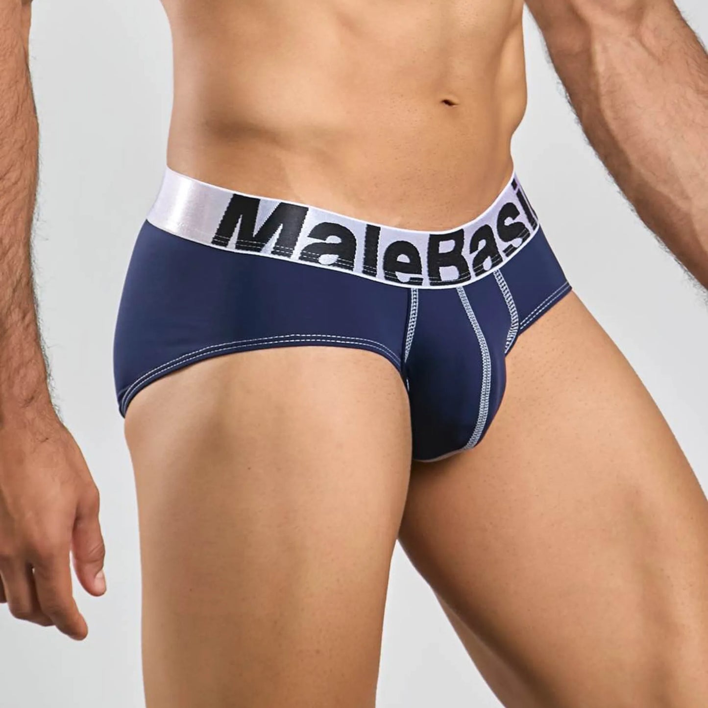 Men's stretch microfiber brief in navy, three-quarter side view showing seam detail