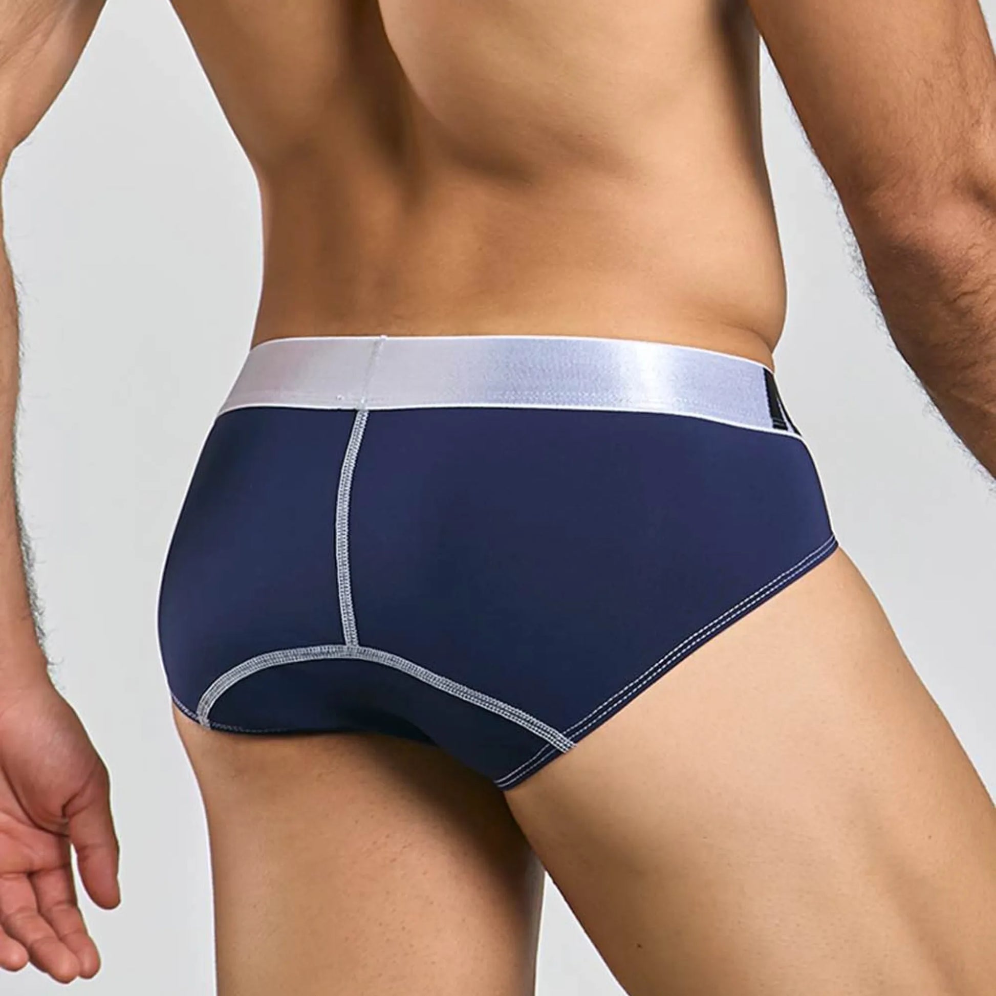 Men's stretch microfiber brief in navy, back view on model