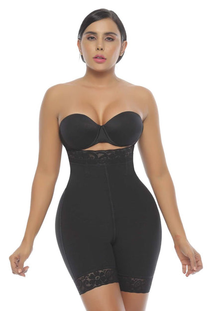 Front angle of a plus-size model in black shapewear control panties, showcasing firm tummy support and a smooth silhouette