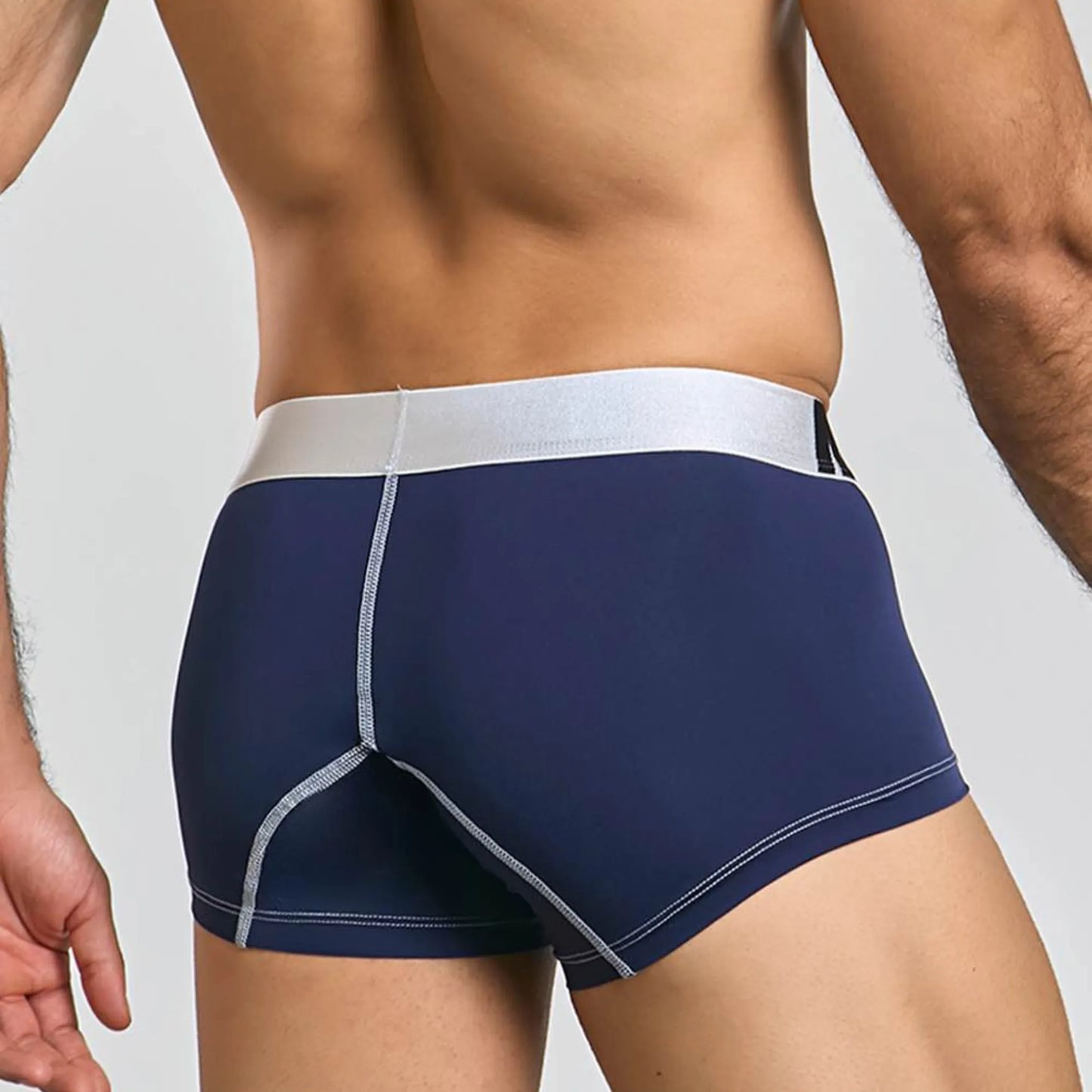 Men's performance microfiber boxer trunk in navy, back view on model