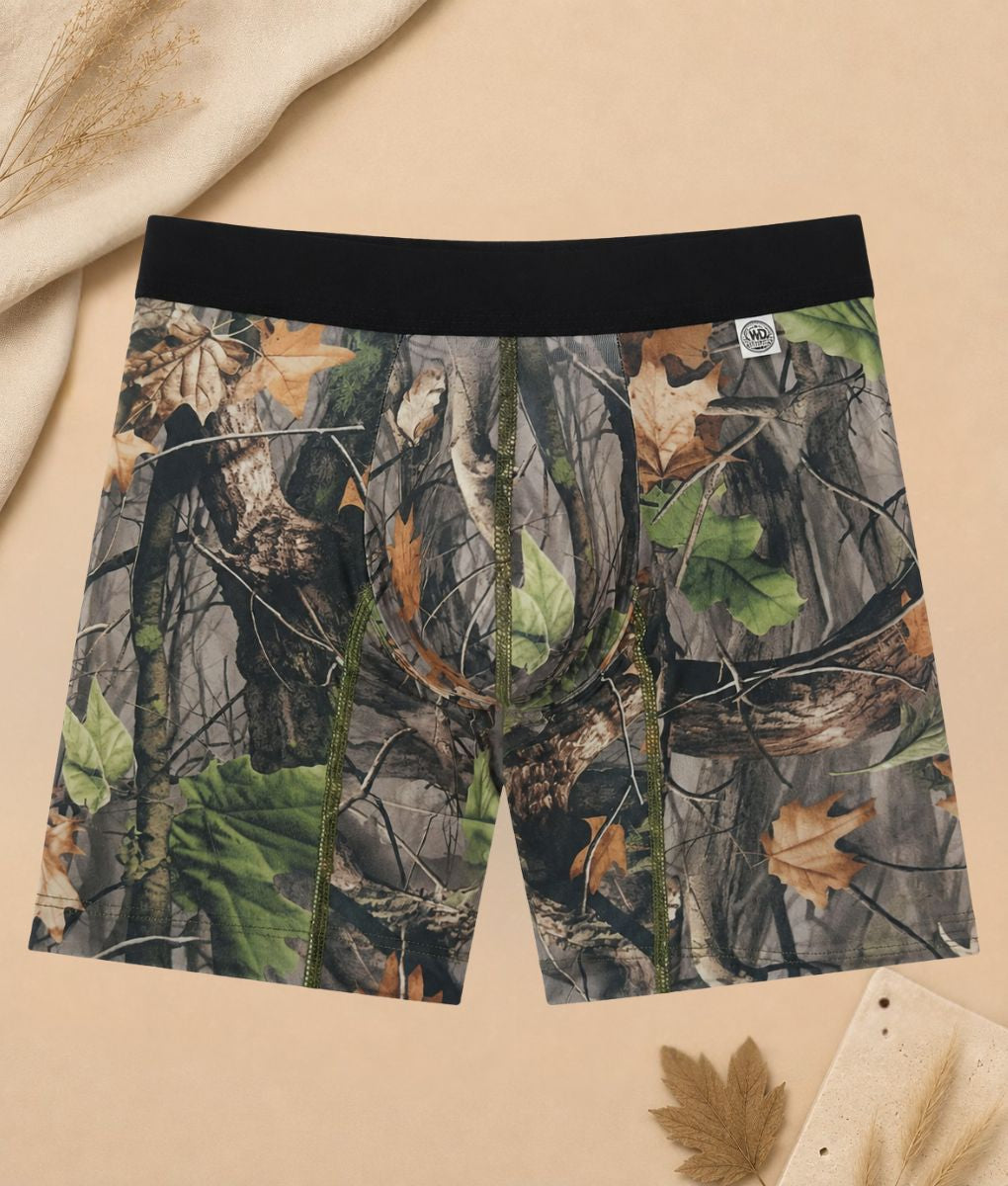 WoodLand camo boxer brief flat lay on beige backdrop with autumn leaves