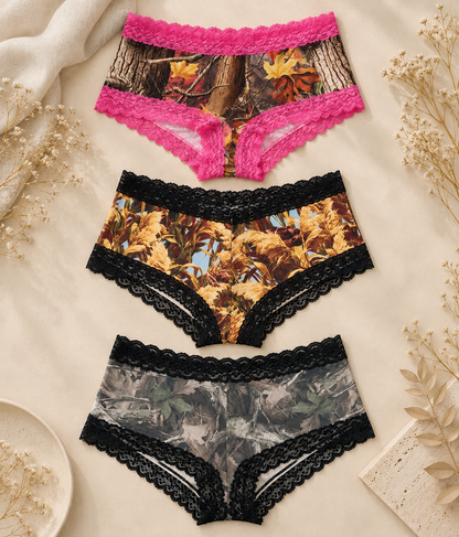 Wilderness Dreams boyshort 3-pack in Magenta Woods, Golden Marsh and Faded with lace trim on a cream flat lay background